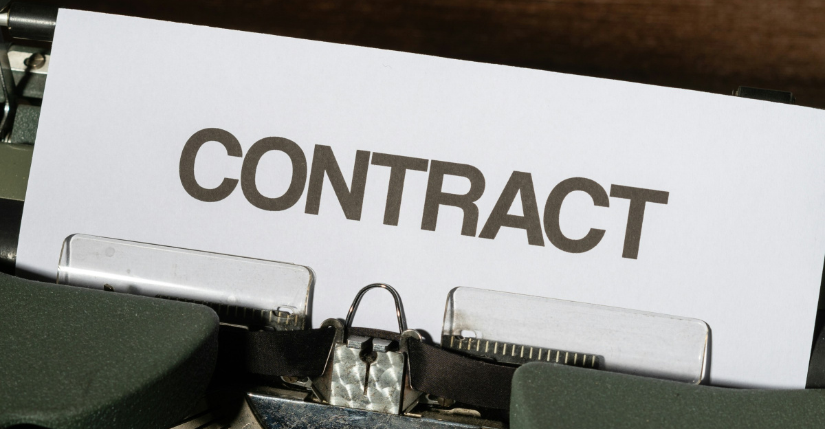 a close up of a typewriter with a sign that reads contact
