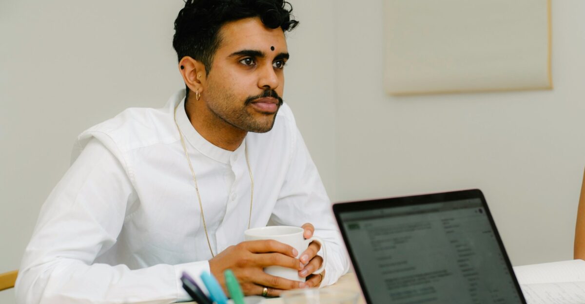 a man sitting in front of a laptop computer
