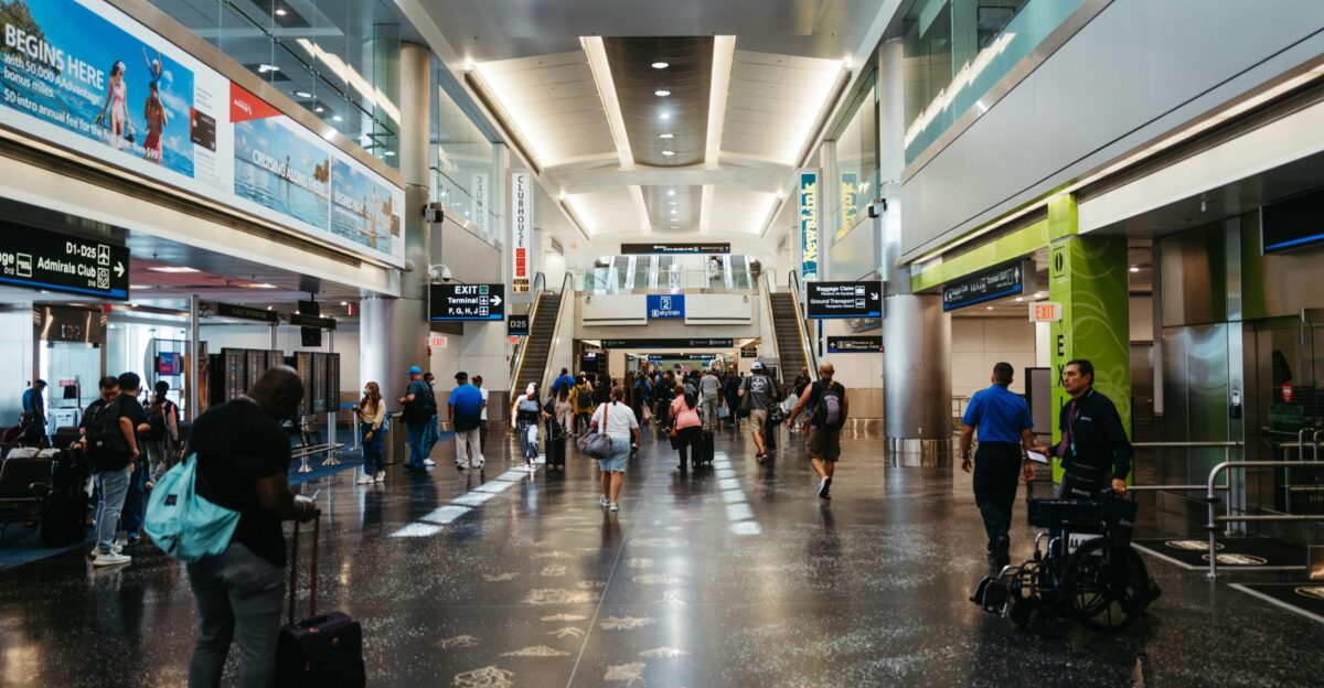 a group of people walking through an airport