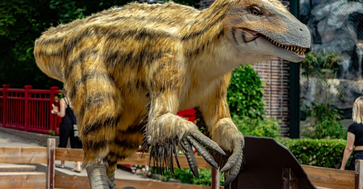 a dinosaur statue on a wooden platform