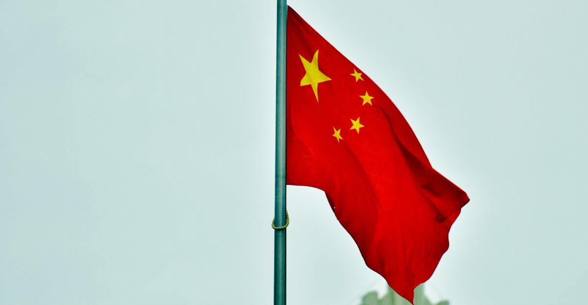 a red and yellow flag on a pole