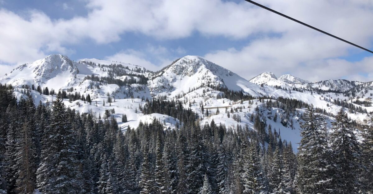 a ski lift going up a snowy mountain