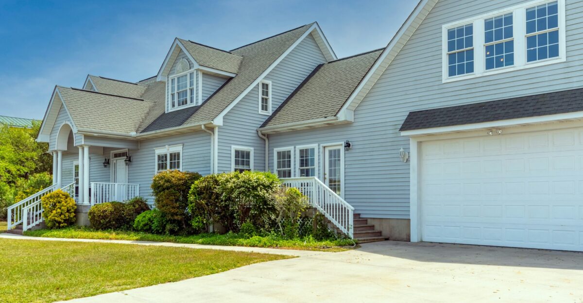 a white house with a large driveway in front of it