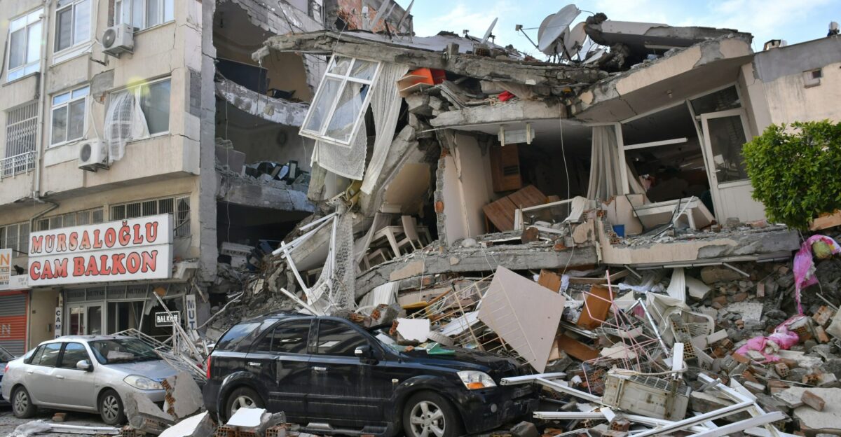 a car is parked in front of a destroyed building