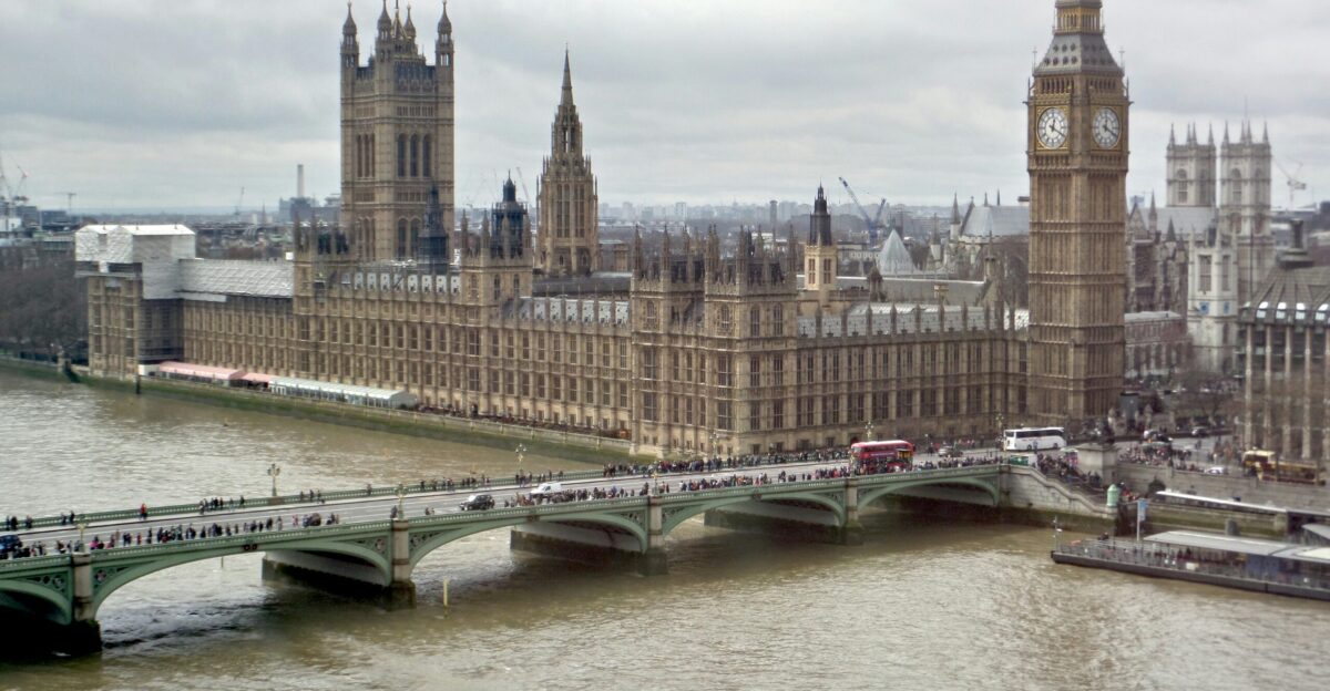 a boat traveling down a river next to a bridge