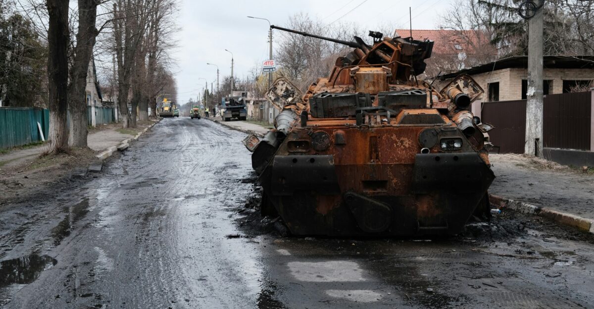 a large rusted out tank sitting on the side of a road