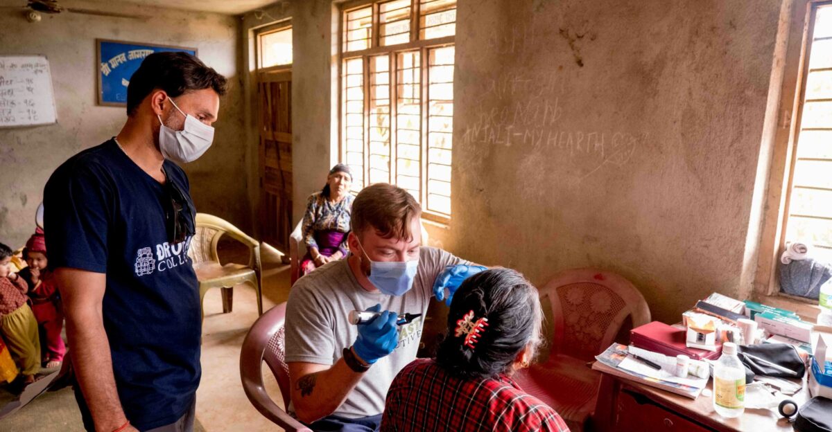 a group of people in a room with masks on