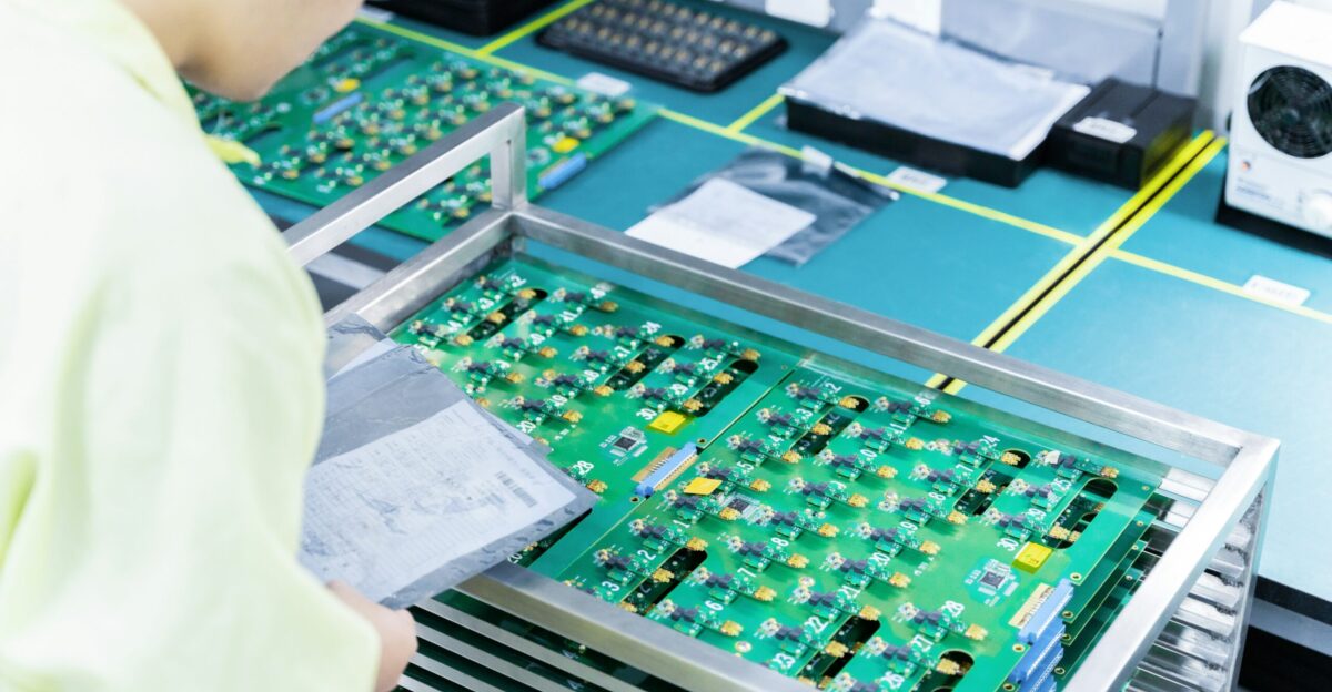 a man working on electronic components in a factory