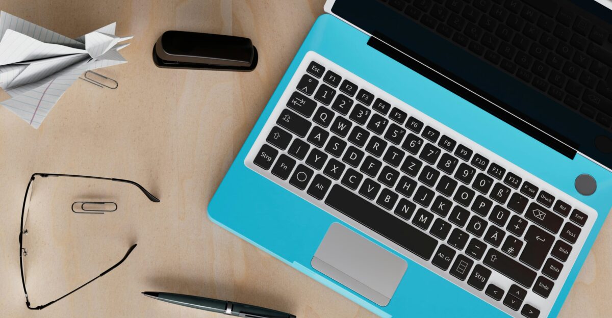 a laptop computer sitting on top of a wooden desk