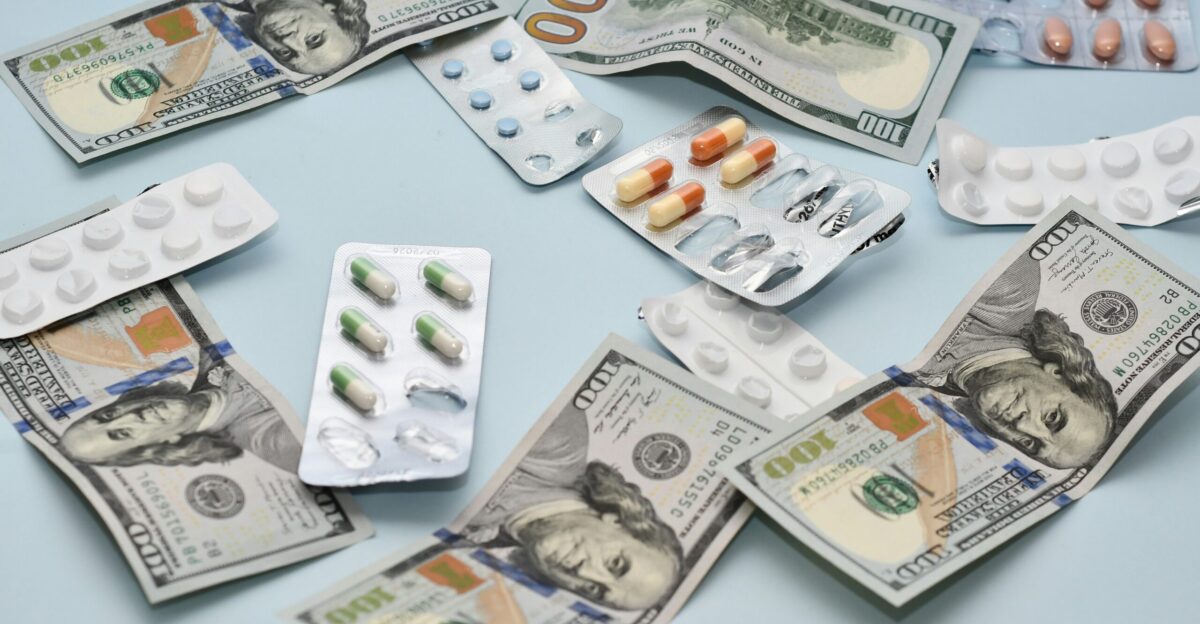 a pile of pills and money sitting on top of a table