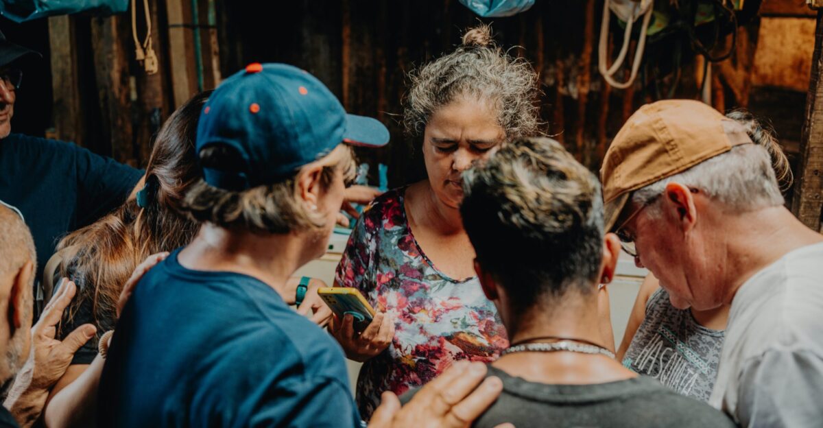 a group of people standing around each other