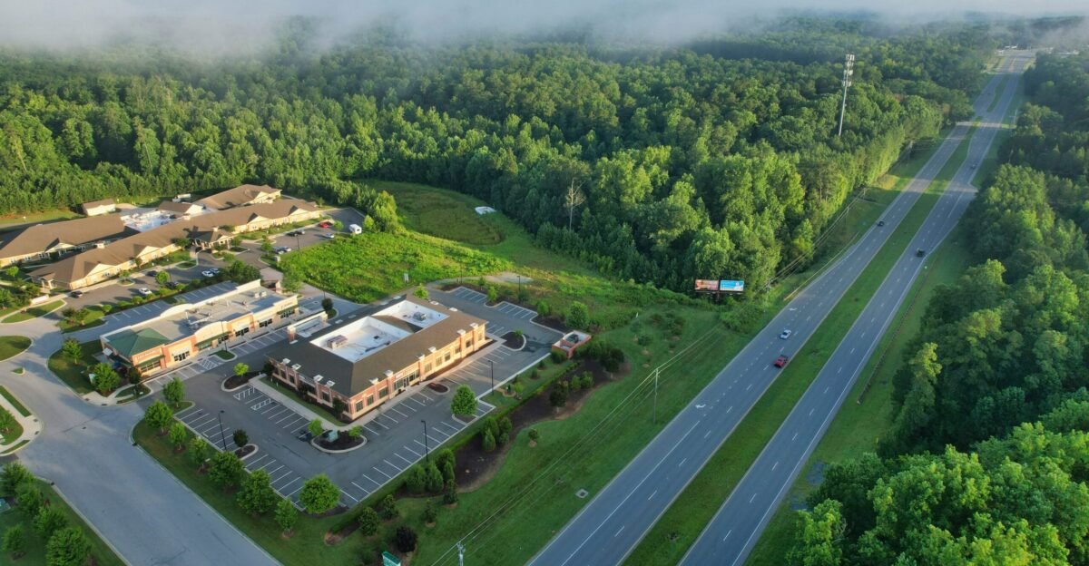 an aerial view of a large building surrounded by trees