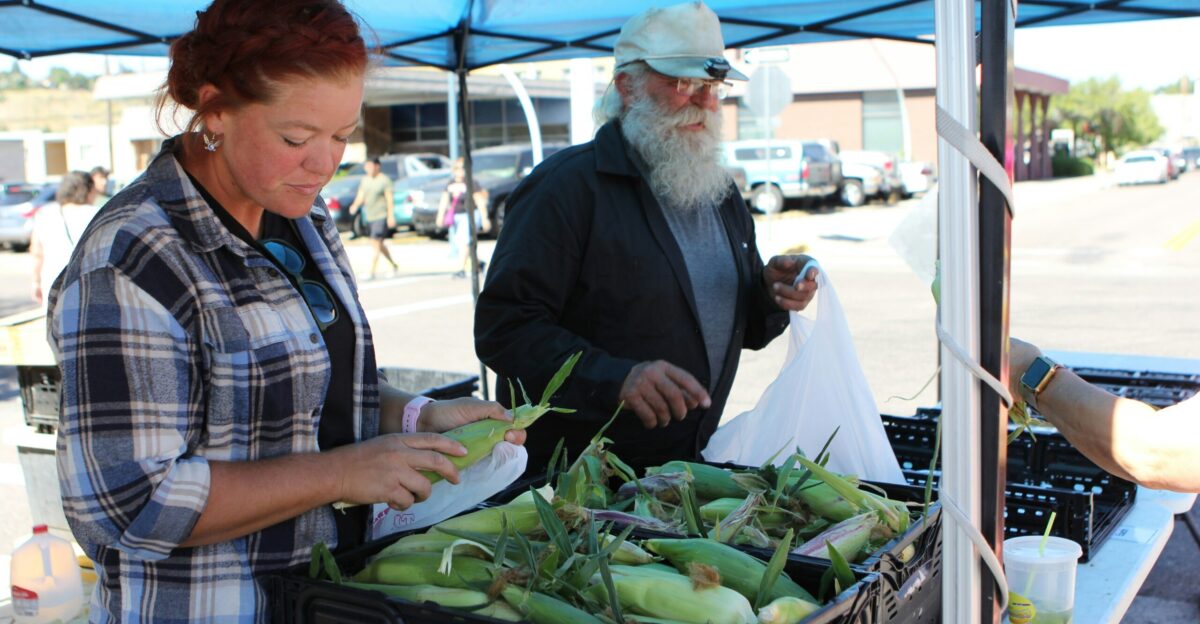 a man and a woman at a farmers market