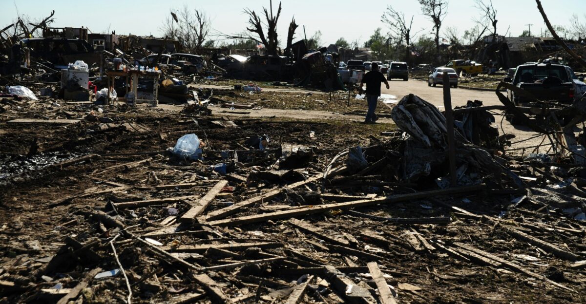 a pile of debris sitting on top of a dirt field