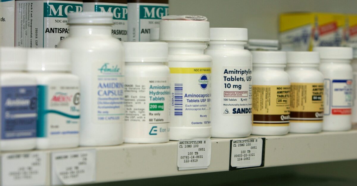 a pharmacy shelf filled with lots of medicine bottles