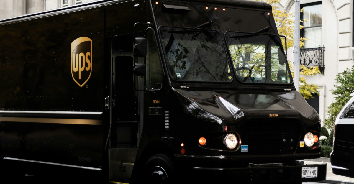 a ups truck driving down a city street