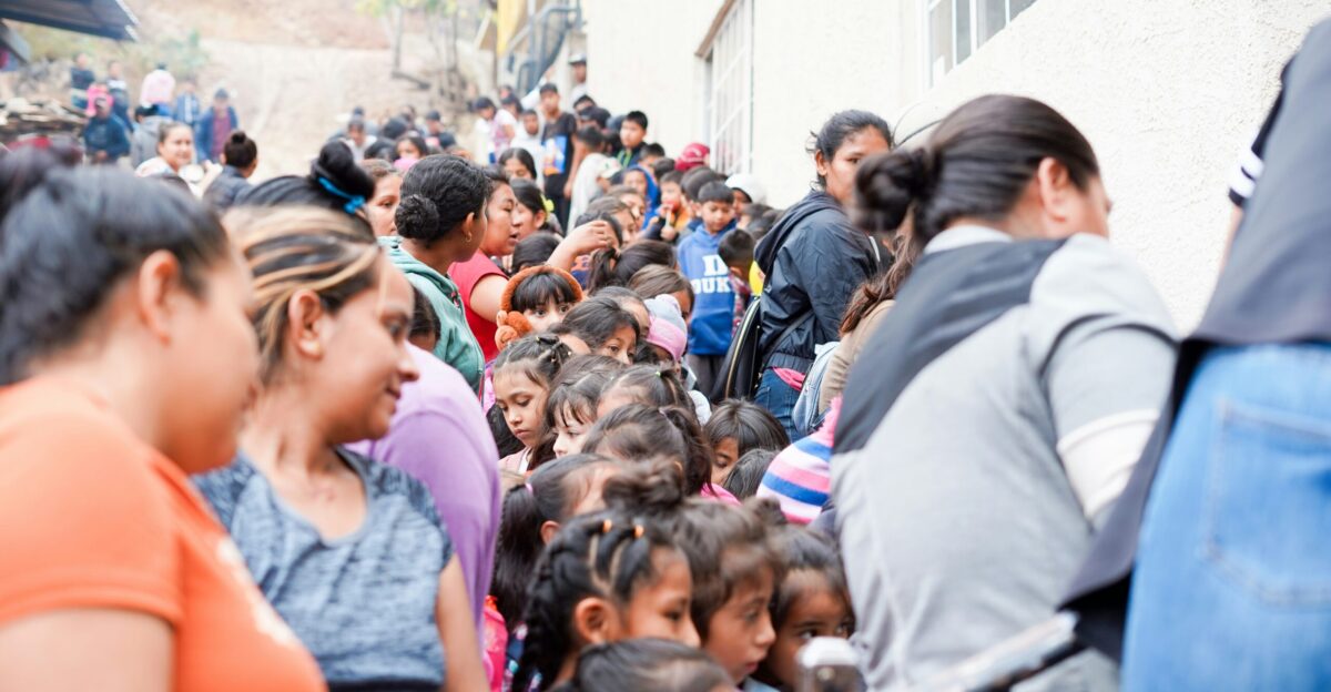 a large group of people are walking down a street