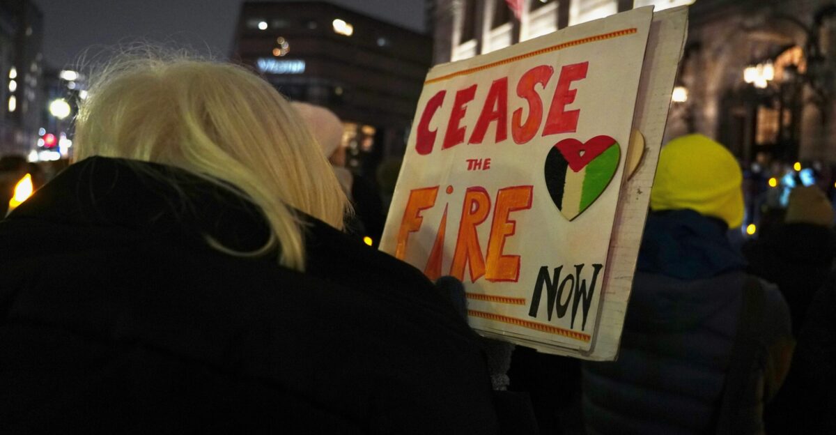 a woman holding a sign that says please the fire now