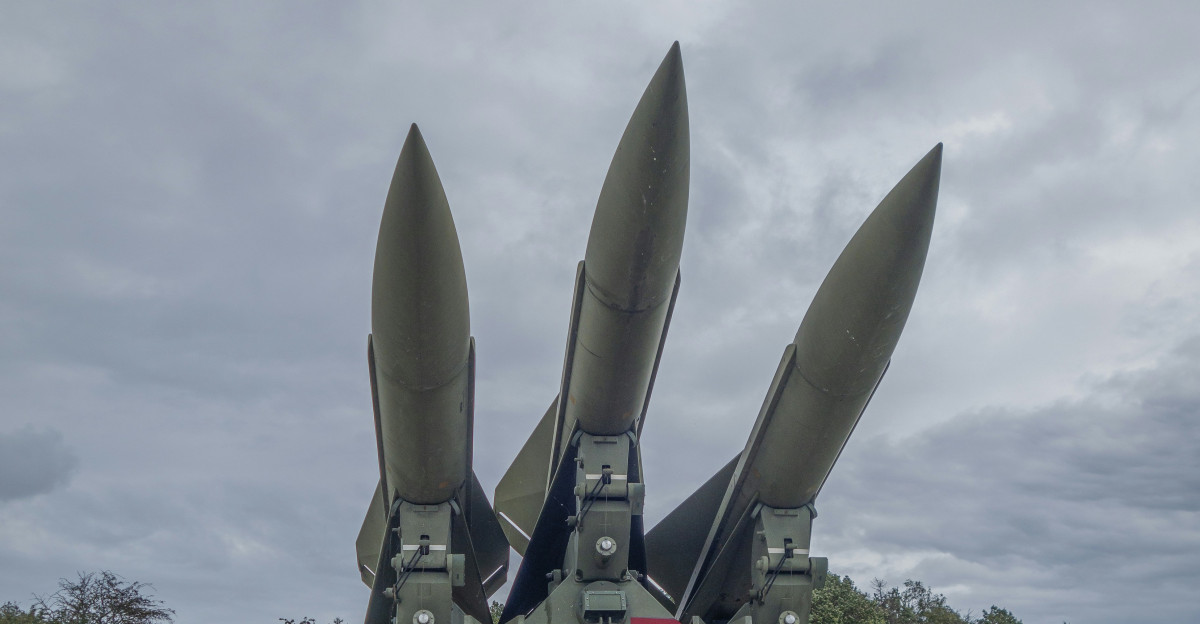 a group of missiles sitting on top of a field