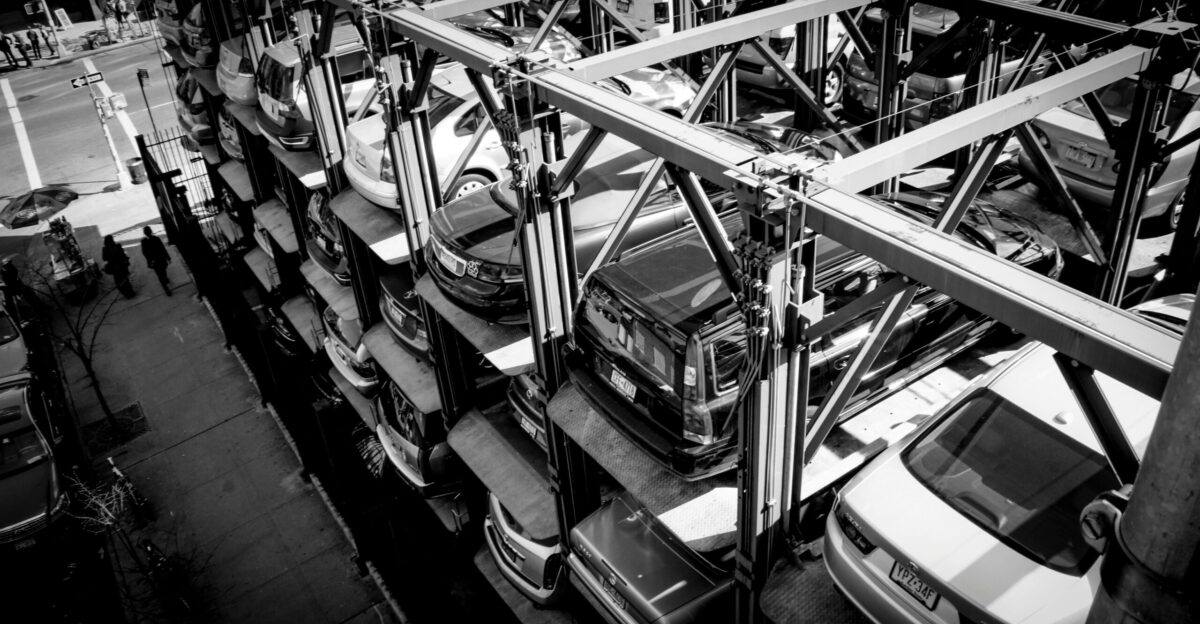 a black and white photo of cars in a parking lot
