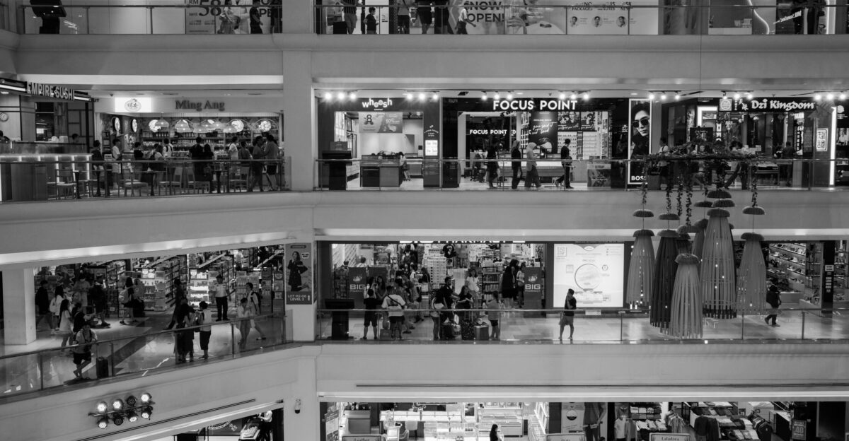 a black and white photo of a shopping mall