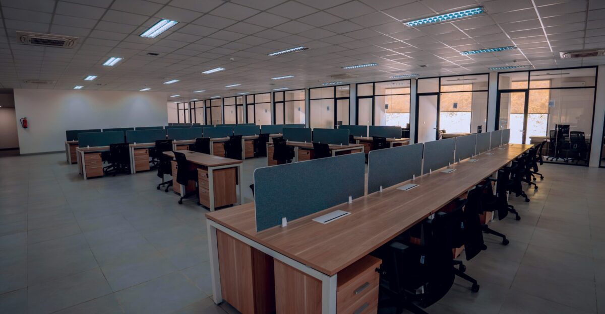 an empty office space with desks and chairs