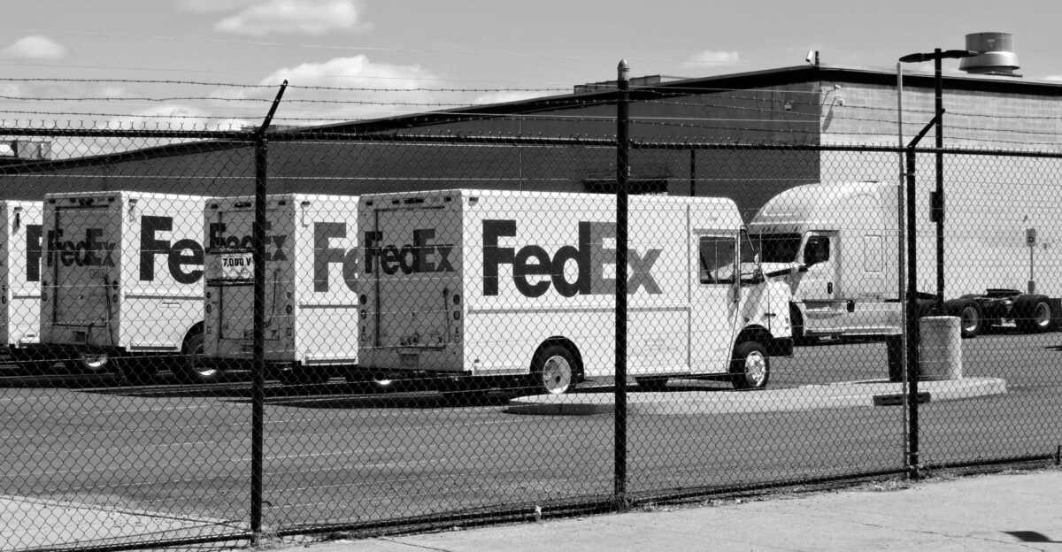 a black and white photo of a fedex truck