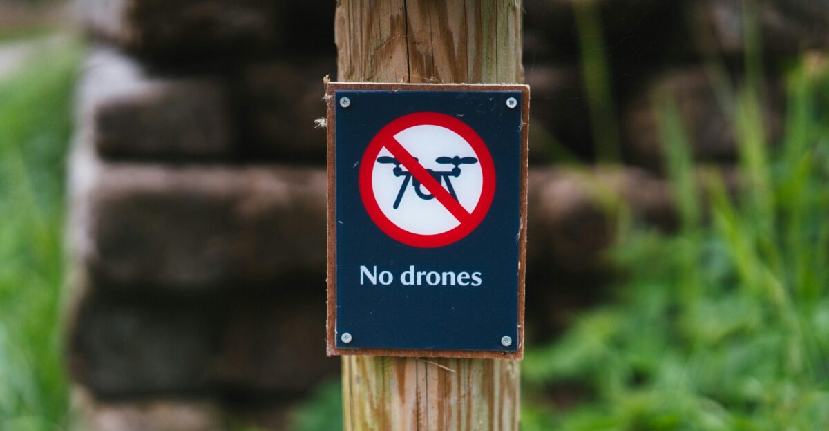 a sign is posted on a wooden post