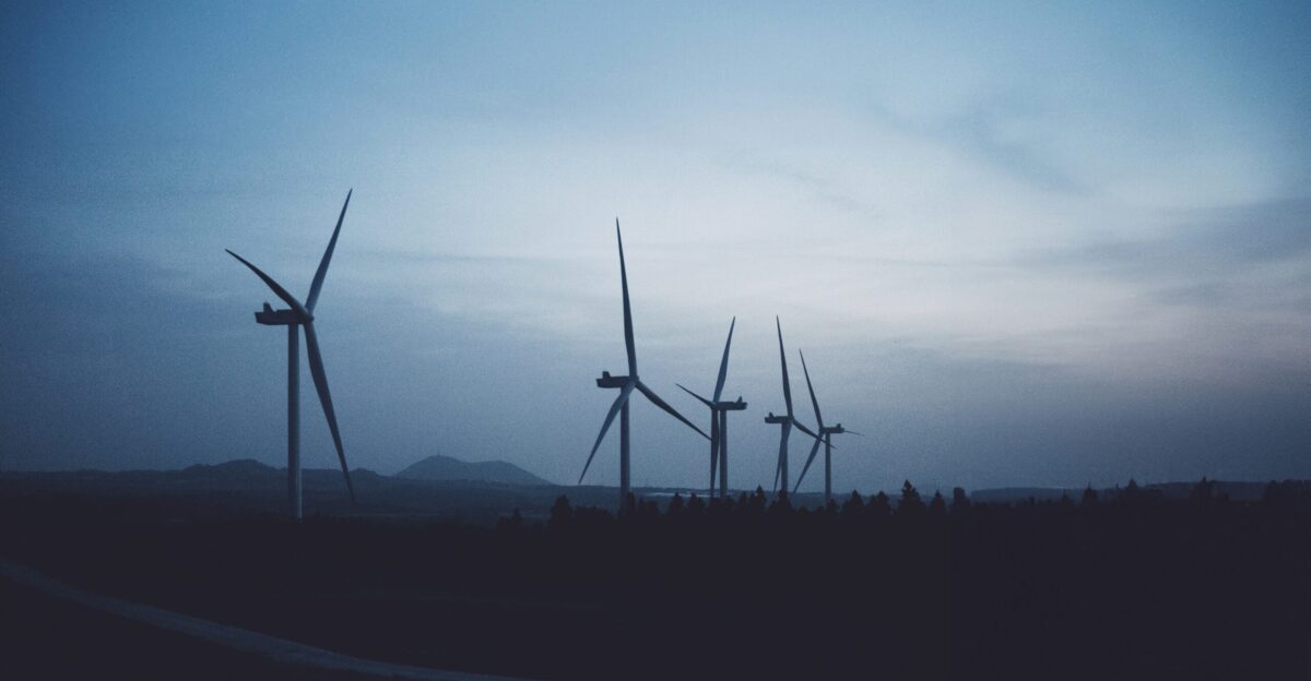 a group of wind turbines in a field