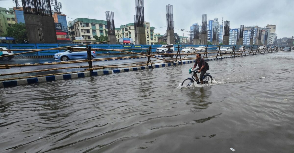 a person riding a bike through a flooded street