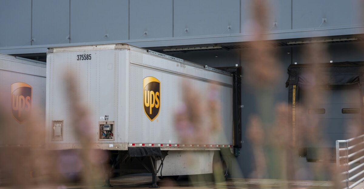 A truck is parked in front of a building