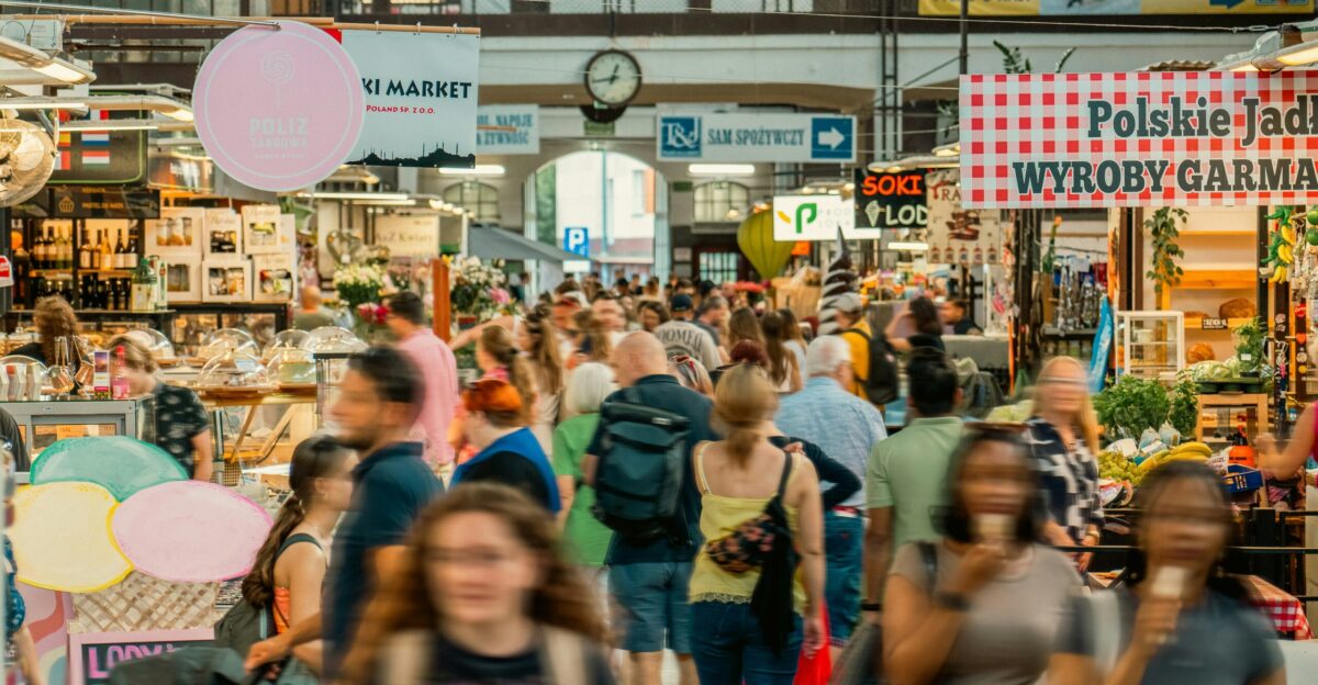 A crowd of people walking through a market