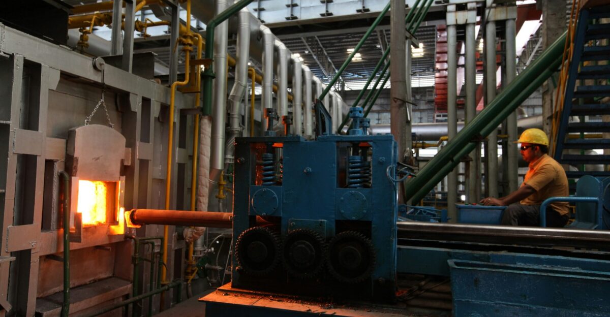 A man in a factory working on a piece of machinery
