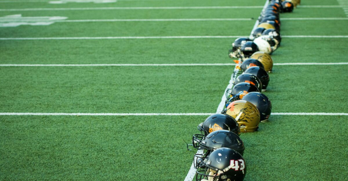 A line of football players lined up on the field