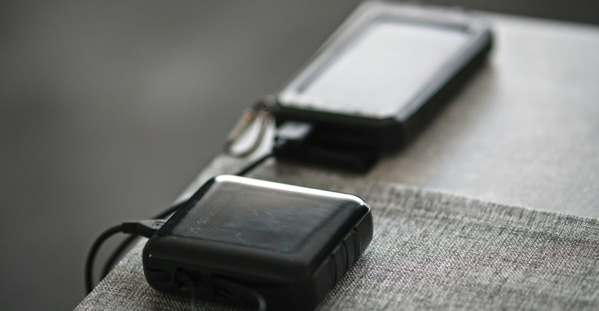 A couple of cell phones sitting on top of a table