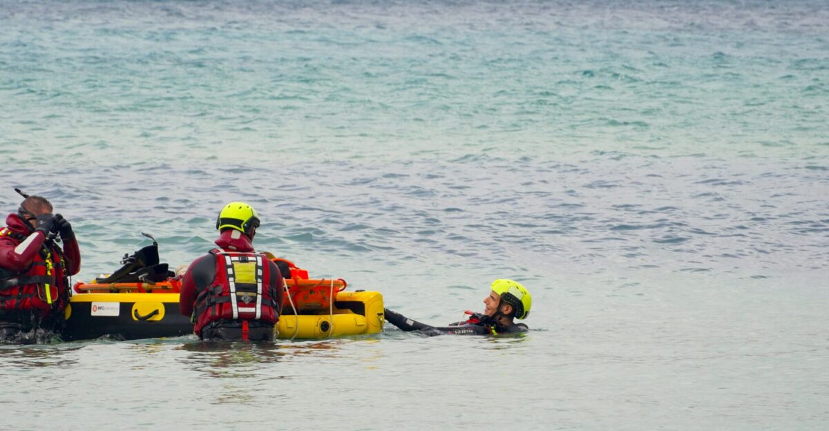 A group of people standing in the water