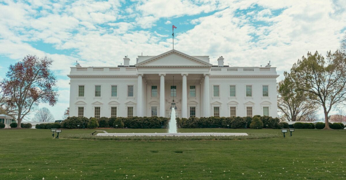 The white house stands under a bright sky