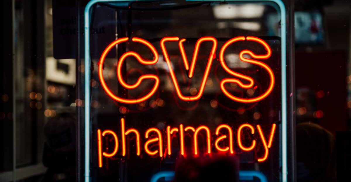 A neon cvs pharmacy sign glows at night