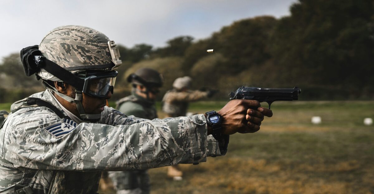 Soldiers practice shooting guns at a firing range