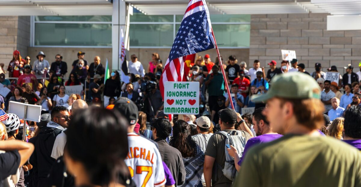Protesters wave flags at an outdoor gathering
