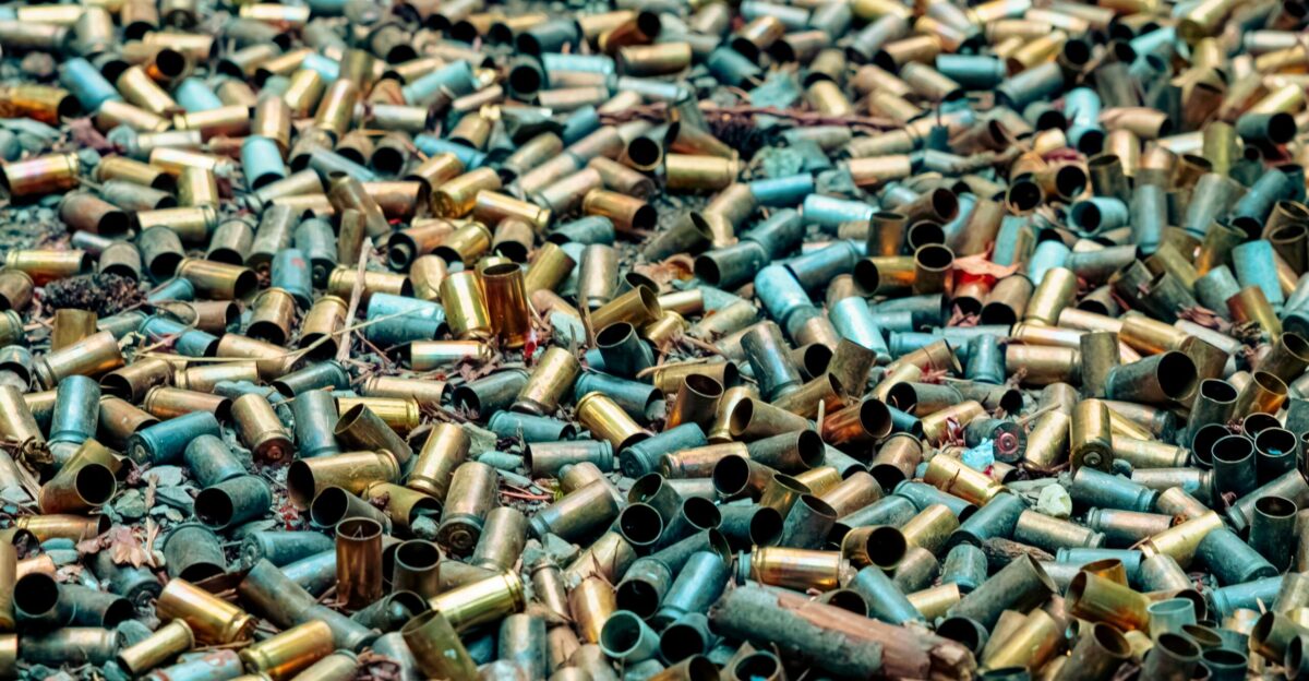 A pile of spent bullet casings on the ground