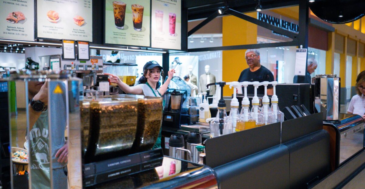 Baristas working behind a coffee shop counter