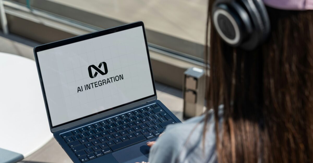 Person using laptop with ai integration logo displayed