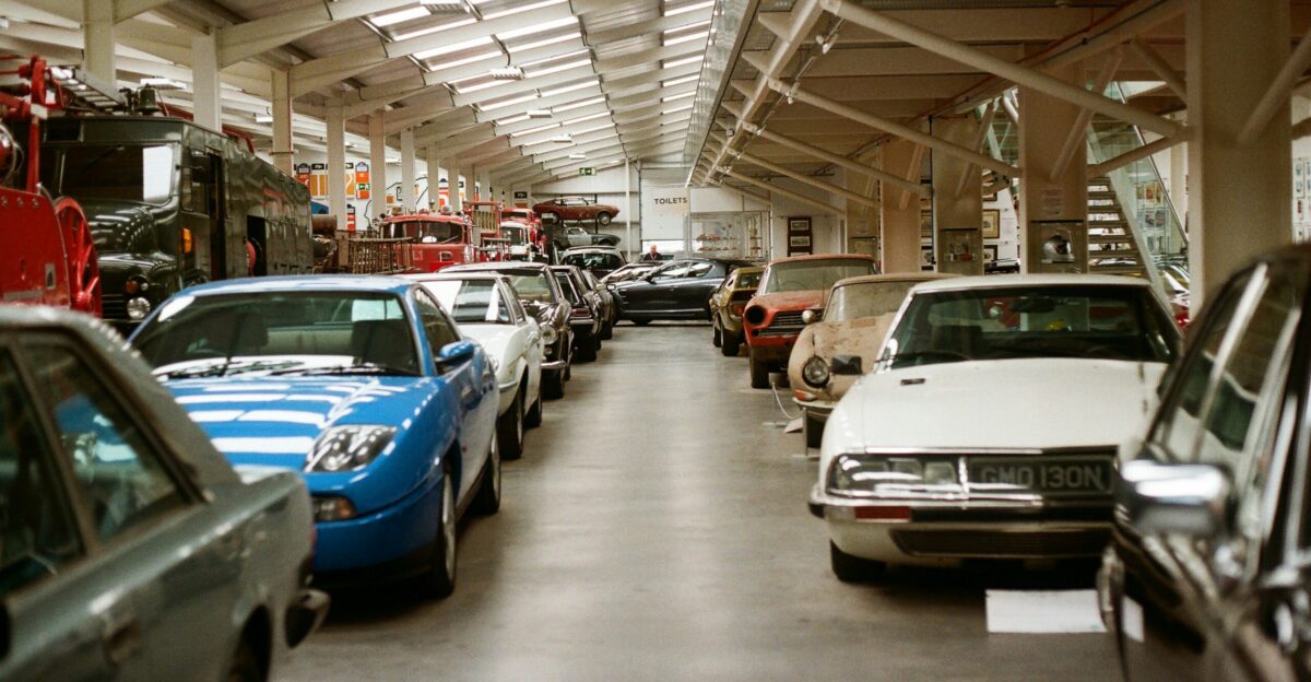 Row of classic cars displayed in a museum hall