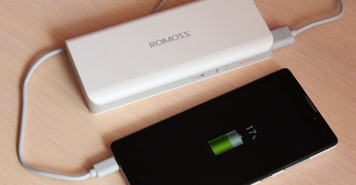 Huawei Honor 3C smartphone being charged from a portable battery charger Romoss Sense 4