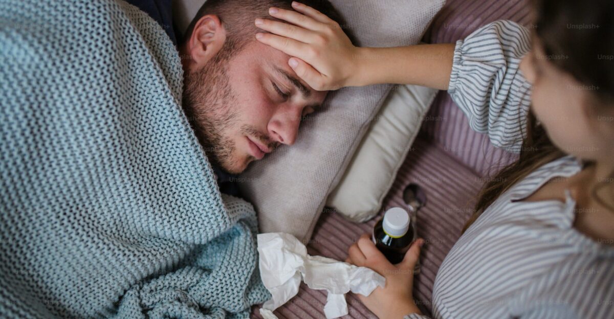 A high angle view of little daughter taking care of her sick