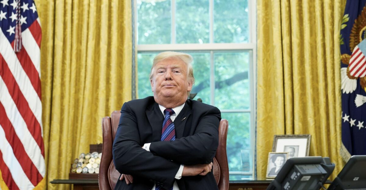 PsBattle President Trump sitting at his desk in the Oval Office