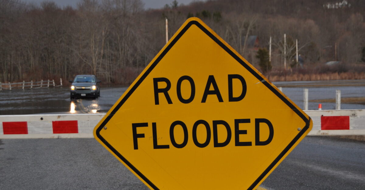 A road flooded sign on Gidley Road in Pleasant Valley New York warning drivers of a flooded roadway following heavy rains and extensive melting snow