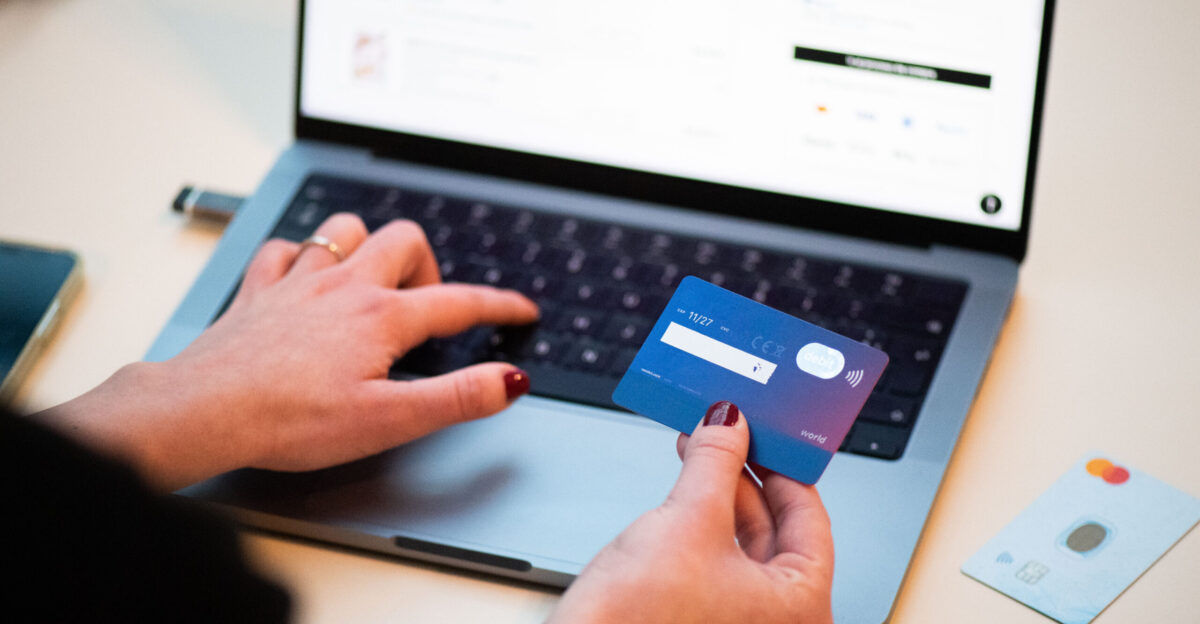 A person using a bank card to shop online