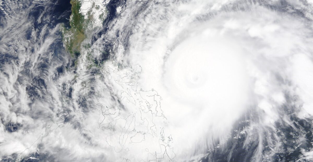 The cloud-filled center of powerful Typhoon Surigae spun in the Philippine Sea as a Category-4-equivalent storm on April 18 2021 as the outer bands brought rain flooding and heavy storm surge to the Eastern Philippines Several regions reported power outages and more than 100 000 people have been evacuated to shelter on higher ground One death has been attributed to the storm The Moderate Resolution Imaging Spectroradiometer MODIS on board NASA s Terra satellite acquired a true-color image of Typhoon Surigae on April 18 when the monster storm was carrying one-minute sustained winds of about 145 mph 233 km spanned more than 600 miles 966 km and had already begun to turn away from the Philippines While impressive this was a substantial weakening from the peak strength reached on the afternoon of April 17 when Super Typhoon Surigae burst into the record books by surging from a 90 mph 145 km h Category 1 storm to become a strong Category 5 storm with one-minute sustained winds of with 190 mph 306 km h and pressure of only 888 millibars in just 36 hours This explosive intensification won Surigae the title of the most intense April typhoon on record The previous strongest April storm was Typhoon Maysak 2015 with a central pressure of 910 mb Based on wind speed alone Surigae also became the strongest typhoon so early in the year beating Typhoon Hester who sported 185 mph 298 km h winds on January 1 1953 Super Typhoon Surigae also became the fifth-strongest typhoon to ever spin in the Pacific Ocean behind Hurricane Patricia 2015 which carried 215 mph 346 km h winds and 872 mb central pressure Super Typhoon Goni 2020 with 195 mph 314 km h winds and 894 mb Super Typhoon Haiyan 2013 with 195 mph winds 314 km h and 895 mb pressure and Super Typhoon Meranti 2016 195 mph winds 314 km h and 890 mb pressure It is possible that stronger typhoons than these have existed but not reliably-measured storms Fortunately Surigae quickly lost the title of Super Typhoon as winds dropped below 150 mph 241 km h and it is turning away from the Philippines It is expected to steadily weaken as it moves away from land over the next several days